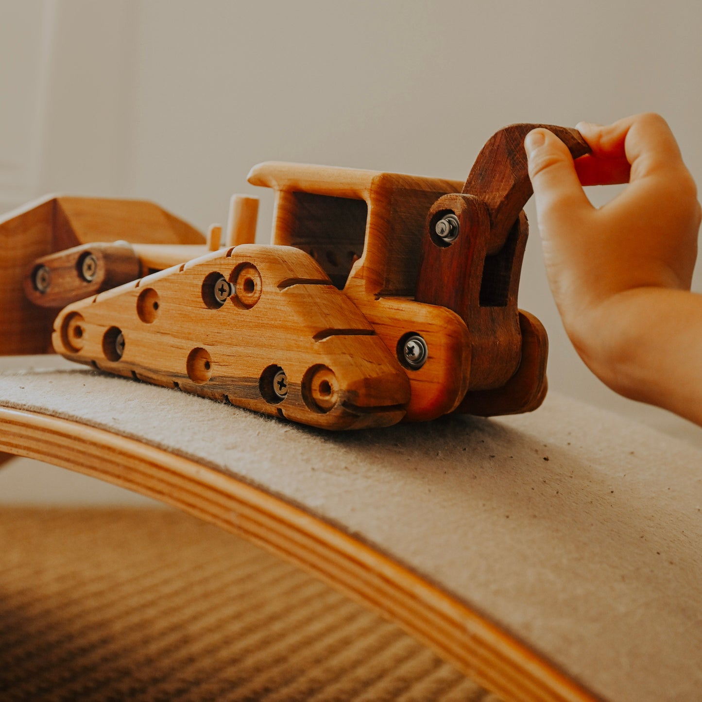 A young boy playing with the functional RIpper on an immaculate and luxurious handmade wooden digger toy. Newborn gift