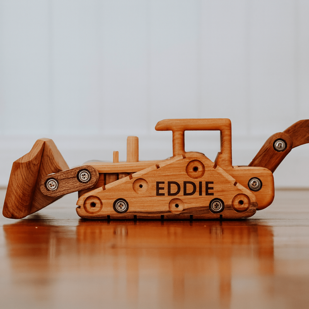 Wooden toy bulldozer with 'EDDIE' on a wooden surface