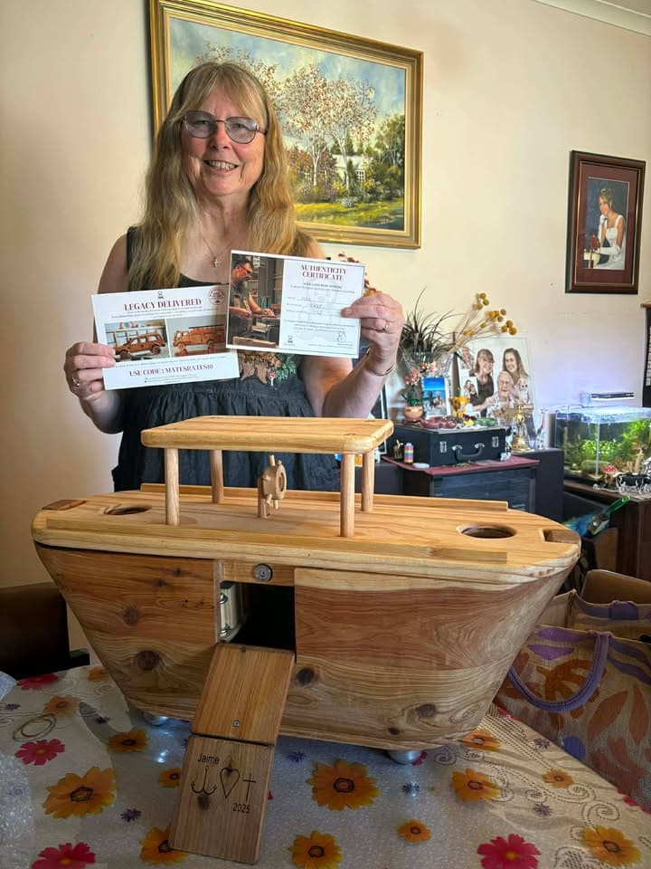 Client standing showing off her Custom Ballard Bear Heirloom Wooden ark, with her certificate of Authenticity.