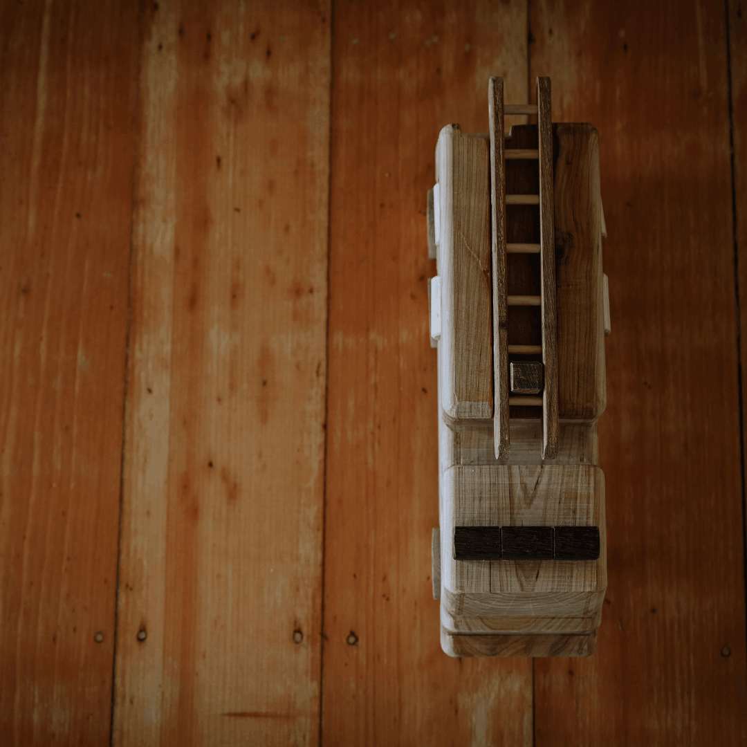Wooden model of a vehicle on a wooden surface