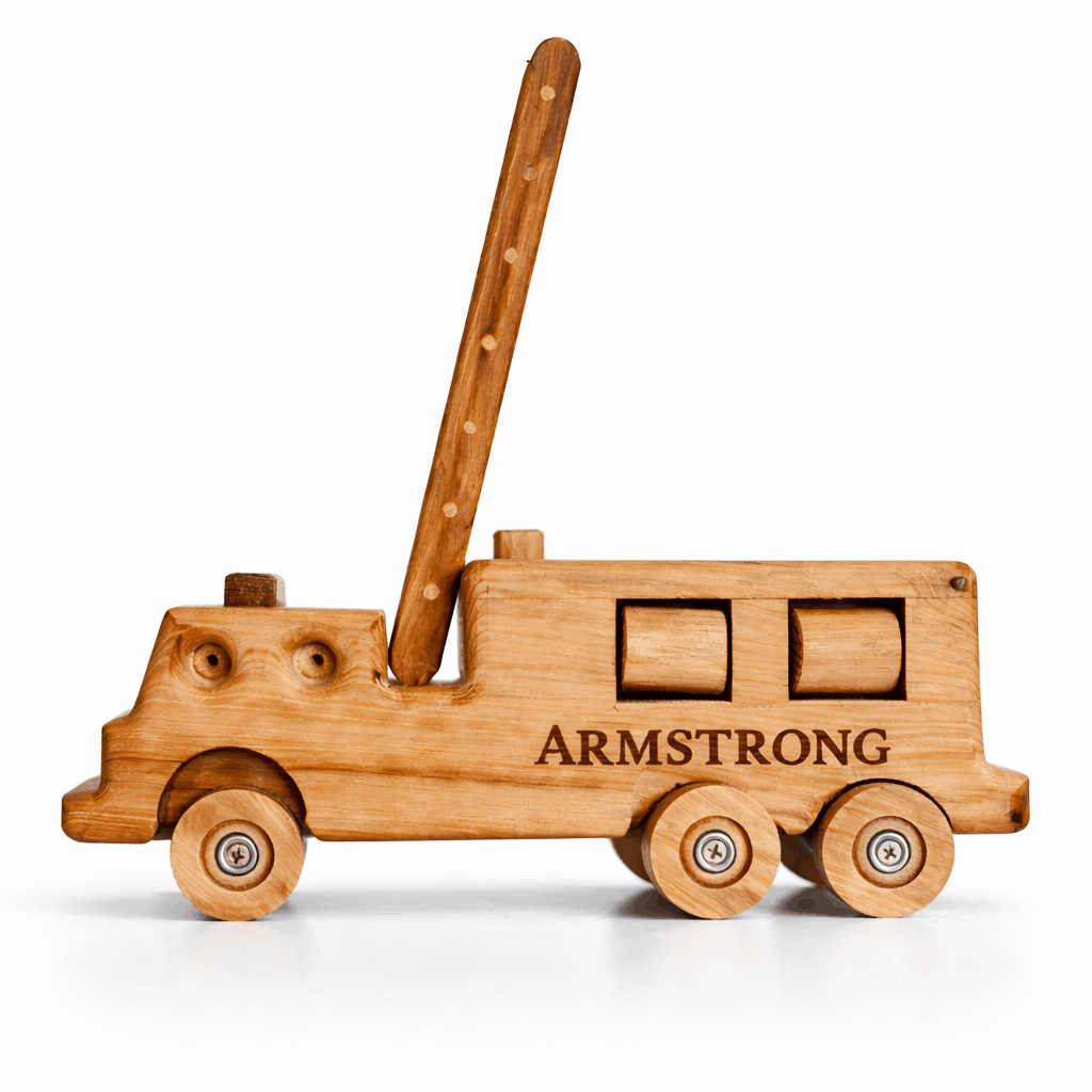 Handcrafted wooden firetruck heirloom engraved “ARMSTRONG” displayed on a crisp white mantel