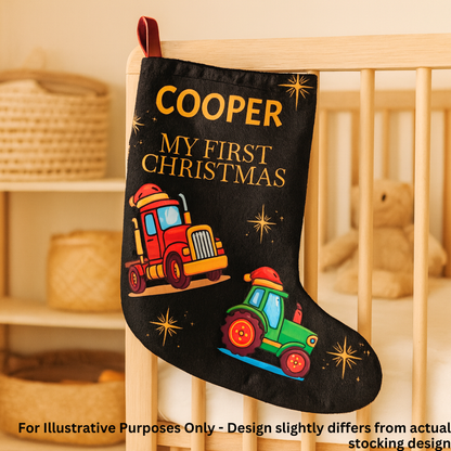 Personalized Christmas stocking with 'Cooper My First Christmas' text and truck design, hanging in a crib.
