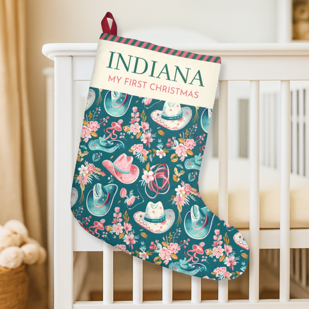 Christmas stocking with 'Indiana My First Christmas' text, floral and cowboy hat design, hanging on a crib.
