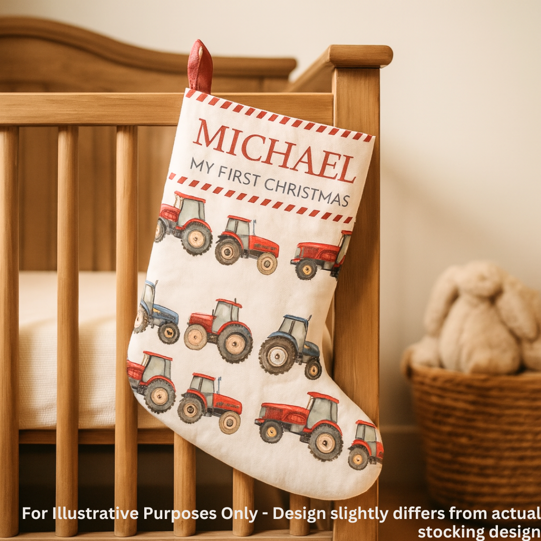 Personalized Christmas stocking with red tractors and 'My First Christmas' text, hanging on a crib.