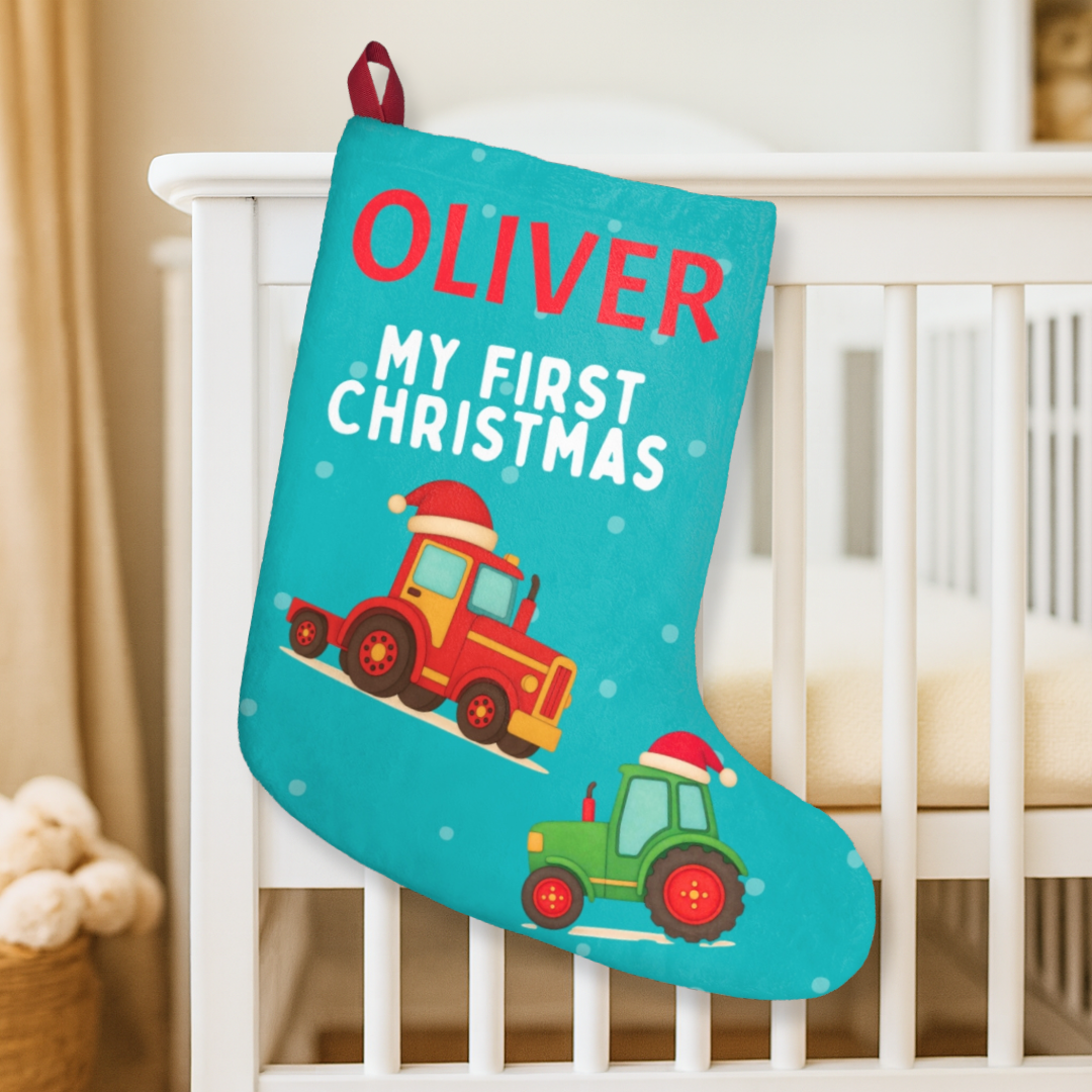 Personalized Christmas stocking for a baby with tractors and text, hanging on a crib.