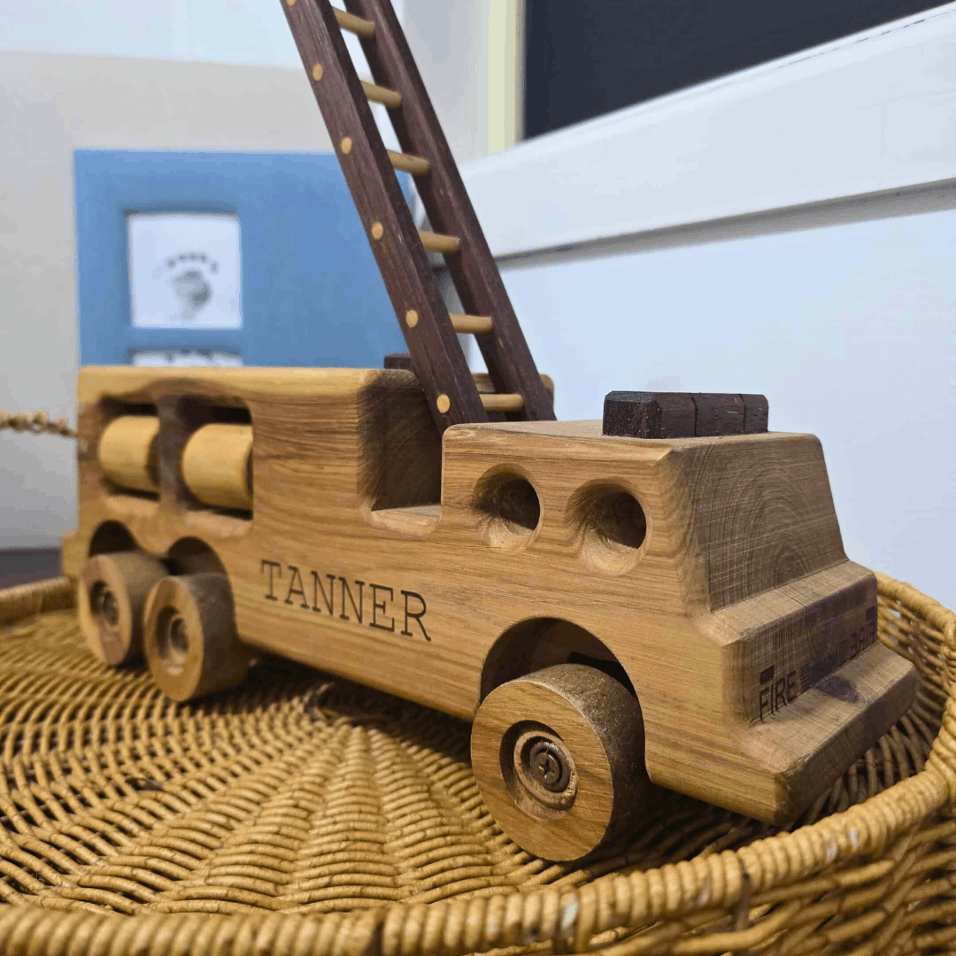A Personalised Engraved Wooden Firetruck, Placed in a Modern Nursery.