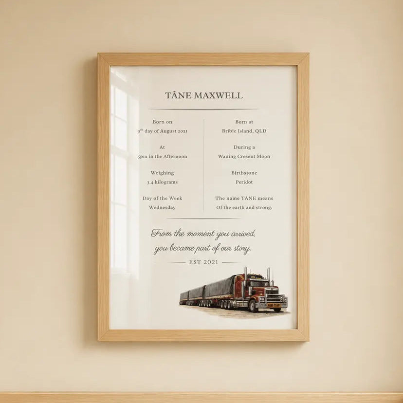 A framed personalized baby nursery print featuring Tashi Maxwell's birth and life details with a vintage red and black train illustration, hanging on a beige wall above a light wood crib. road train