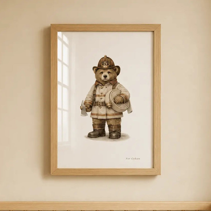 A framed art print of a teddy bear dressed as a firefighter hangs on a beige wall above a light wood crib with white bedding. fire truck collection 