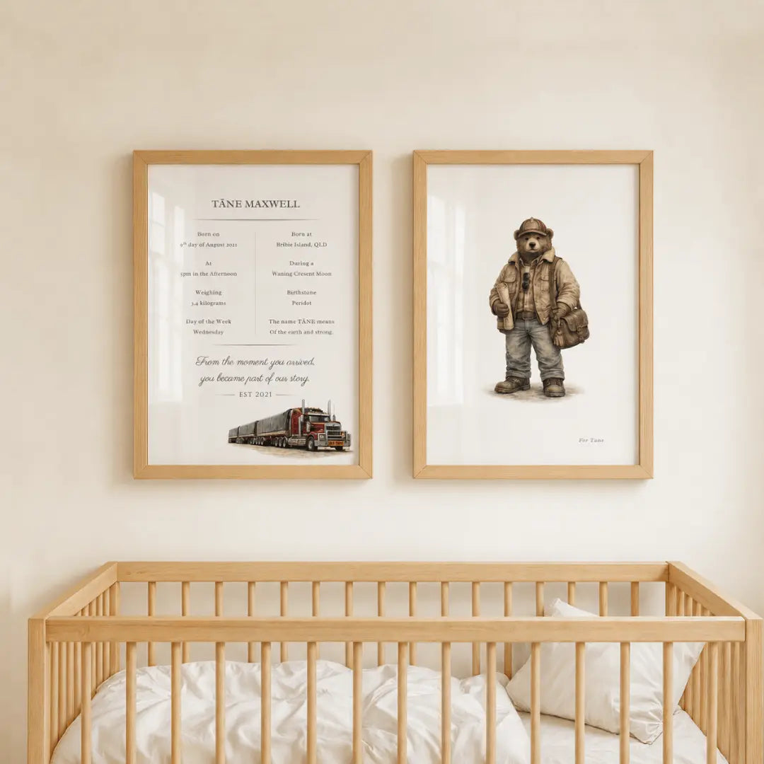 Two framed wall art prints displayed above a light wood crib in a nursery. The left print is a personalized memorial-style text layout titled 'TANSH MAXWELL,' and the right print shows a teddy bear illustration with a train. road train