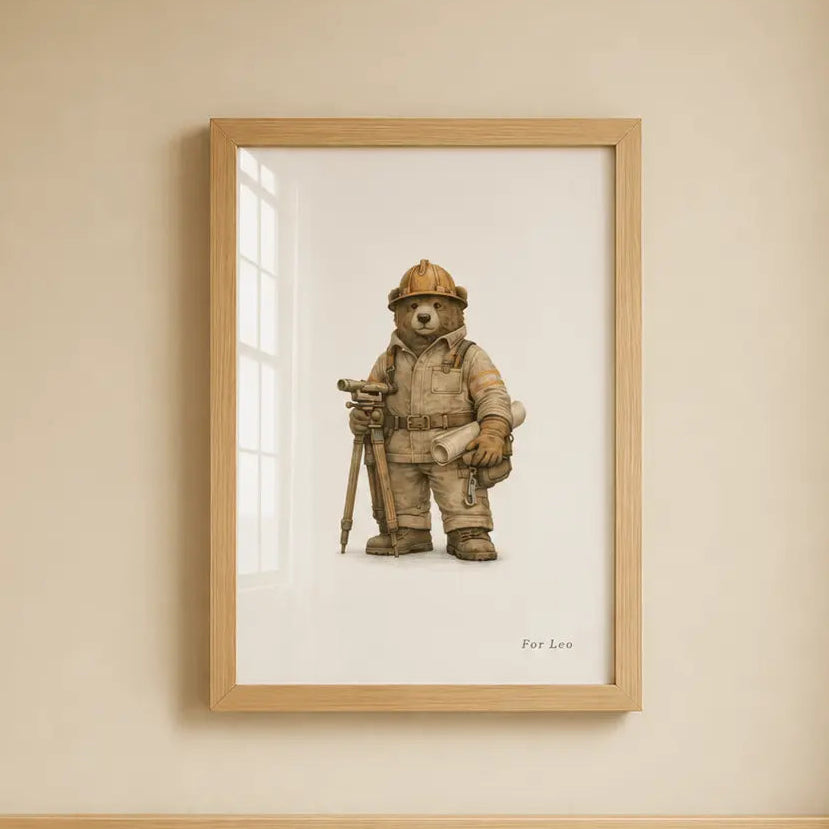 A framed art print of a excavator bear hanging on a beige wall above a light wood crib.